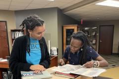 Chinyere Neal (left) and Jamillah Bell review documents